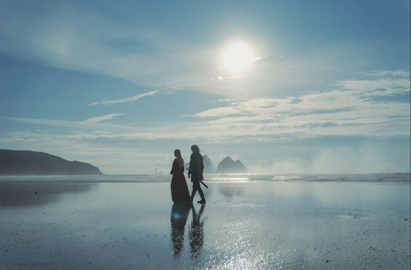 Rhaenyra and Laenor walking along the shore of Driftmark